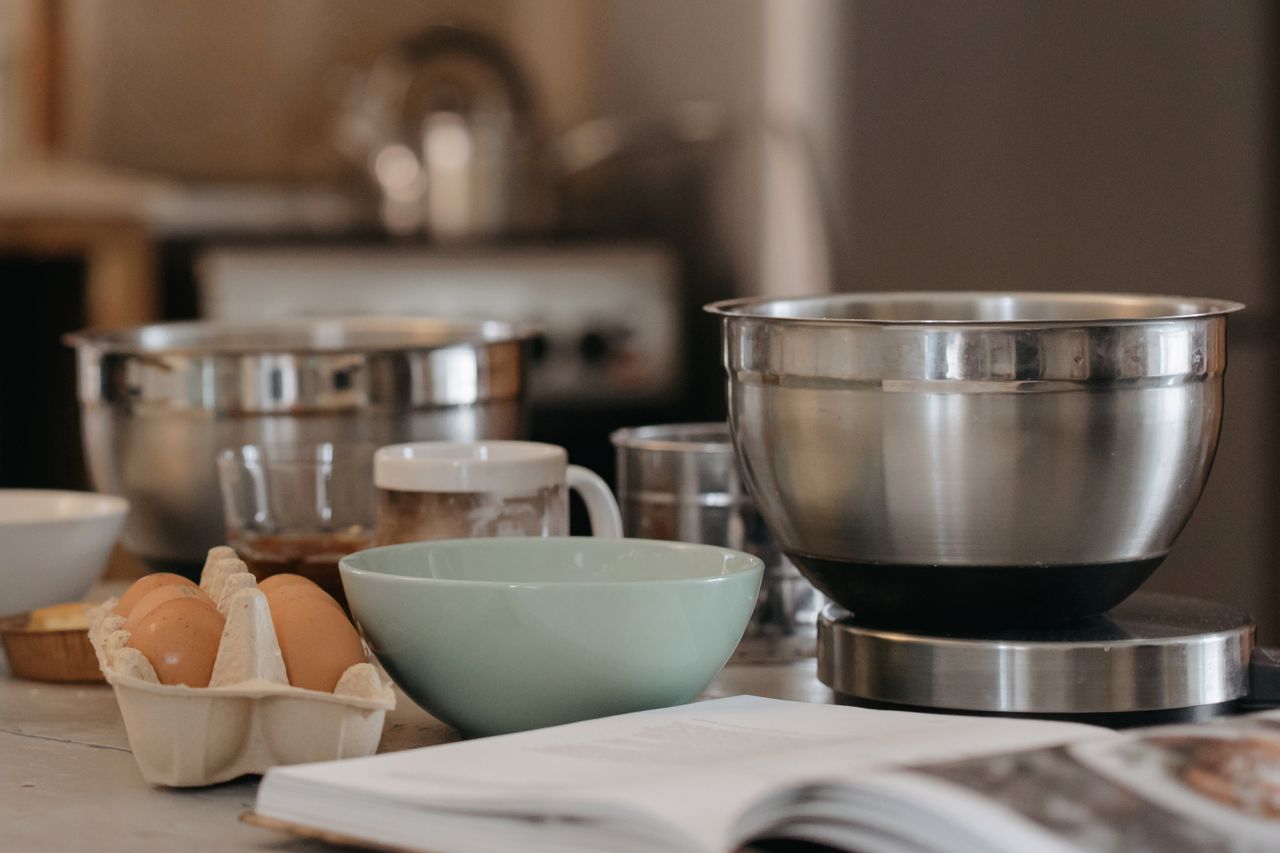 services-01 A cozy kitchen setup with baking bowls, eggs, and kitchen utensils for a comforting cooking experience.