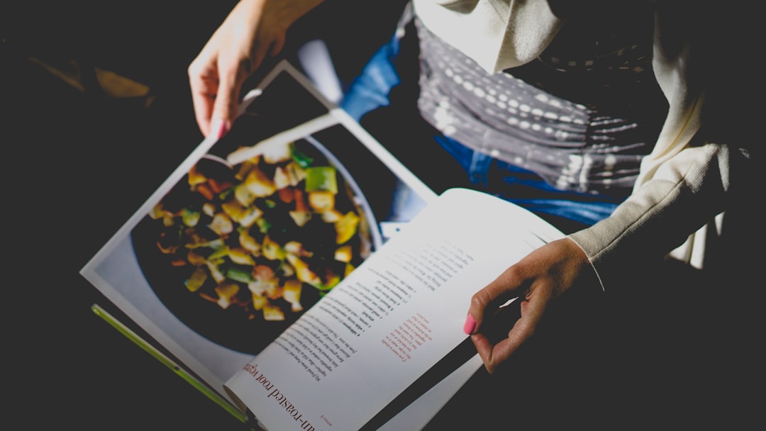 services-04 Person reads cookbook recipe